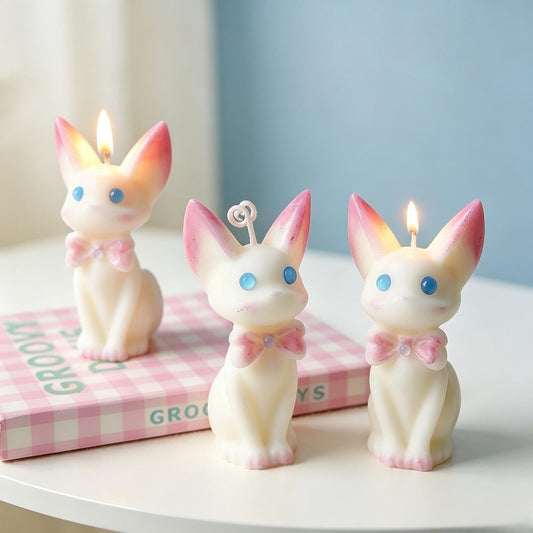 Alternate view of the cat candle with pink bow.