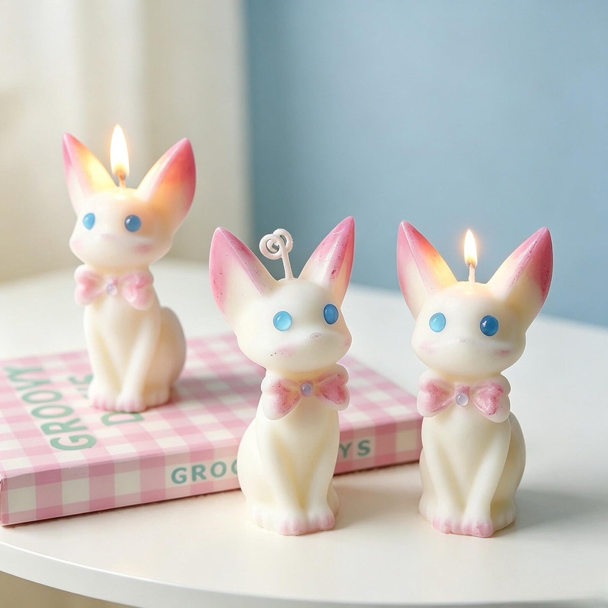 Alternate view of the cat candle with pink bow.