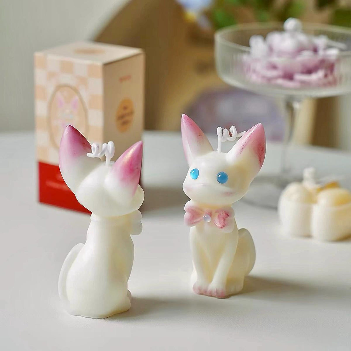 Alternate view of the cat candle with pink bow.